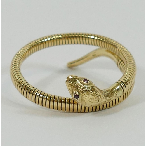 153 - A 9 carat gold and sprung bangle in the form of a snake, Chester 1956, with gem set eyes, 21.9g gros... 