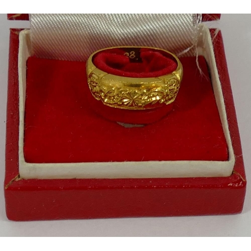 154 - A yellow metal ring, stamped '99' with inscription 'T.T.C. KOREA 1968.5.28', 11.1g gross, finger siz... 