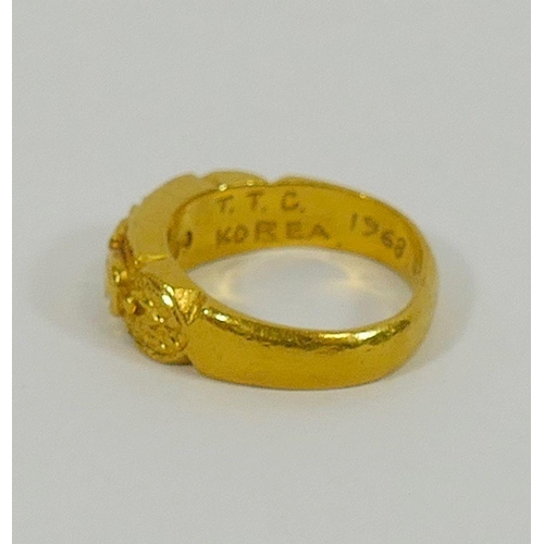 154 - A yellow metal ring, stamped '99' with inscription 'T.T.C. KOREA 1968.5.28', 11.1g gross, finger siz... 