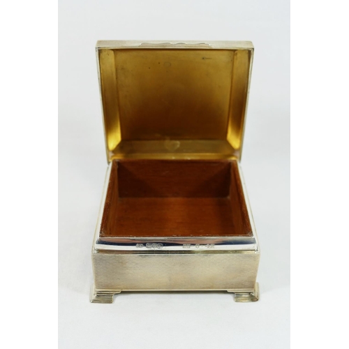 181 - A George V square silver cigarette box, Chester 1921, with engine turned decoration and bearing armo... 