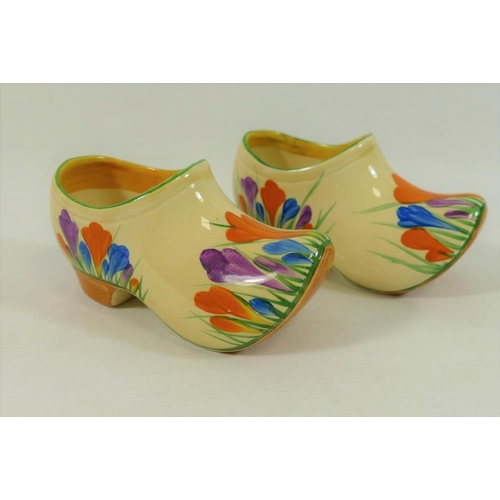 20 - A pair of Clarice Cliff crocus pattern clogs, with painted Bizarre pattern marks, 11cm long