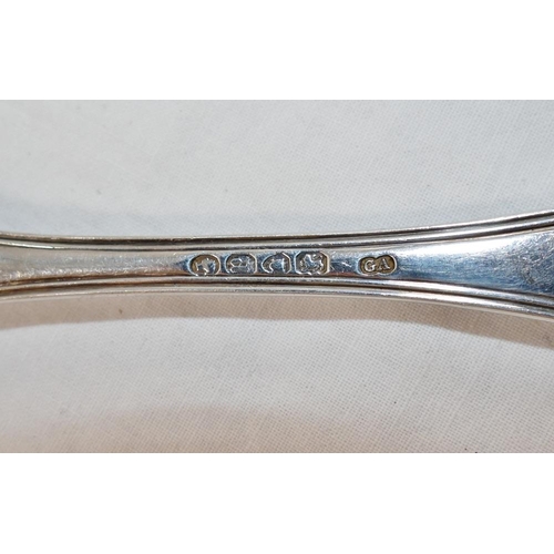 124 - A set of six Victorian silver reeded pattern table spoons with scroll cartouche terminals, London 18... 