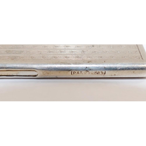 143 - A small silver cased retractable comb with import marks for London 1926, with engine turned decorati... 