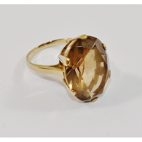 180 - A 9 carat gold smokey quartz single stone ring, the oval mixed cut stone in claw setting, London 197... 