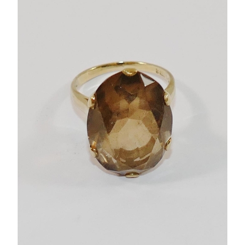 180 - A 9 carat gold smokey quartz single stone ring, the oval mixed cut stone in claw setting, London 197... 