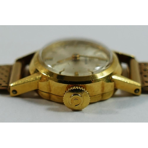 211 - An 18 carat gold cased Cyma ladies bracelet watch, the circular face with silvered dial and gilt bat... 