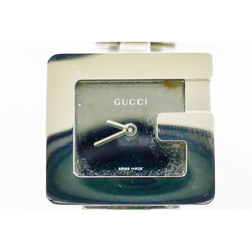 216 - A ladies Gucci stainless steel bracelet watch, the square plain black face within stylised 'G' surro... 