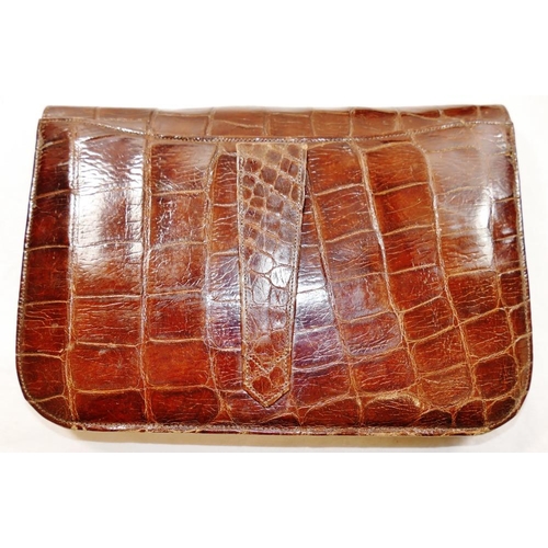 252 - A 1930s crocodile skin clutch bag, 24cm wide, a crocodile skin handbag, with adjustable strap and fa... 