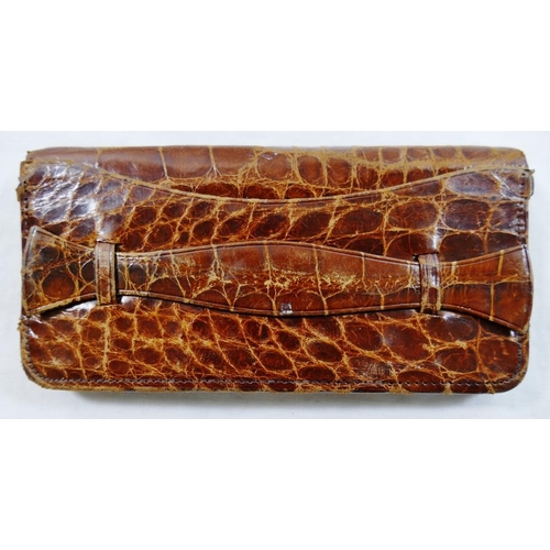 252 - A 1930s crocodile skin clutch bag, 24cm wide, a crocodile skin handbag, with adjustable strap and fa... 