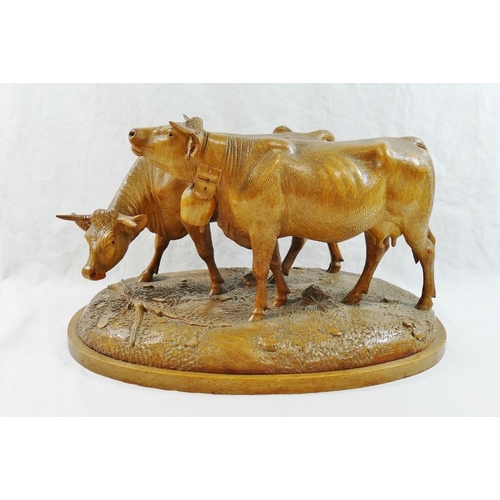 309 - A Swiss Brienz carving of two horned cows, one with a bell, by the  Huggler brothers and stamped 'Hu... 