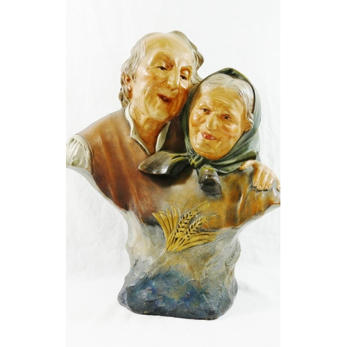 310 - Ezio Ceccarelli (1865-1927), a painted pottery group of an elderly peasant couple laughing, with imp... 