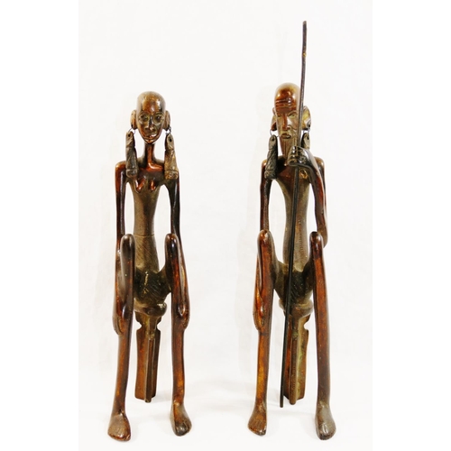 312 - A pair of 20th century bronze Lobi style figures of a West African tribal couple, both seated on sto... 