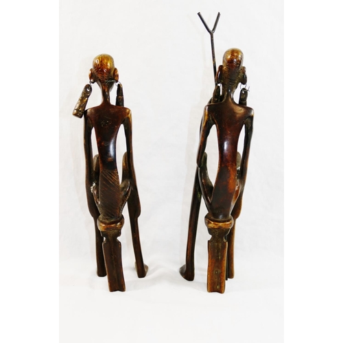 312 - A pair of 20th century bronze Lobi style figures of a West African tribal couple, both seated on sto... 