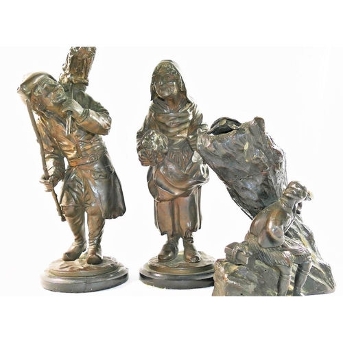 314 - A pair of bronze figures of elderly peasants carrying bundles of sticks, on circular marble base, th... 