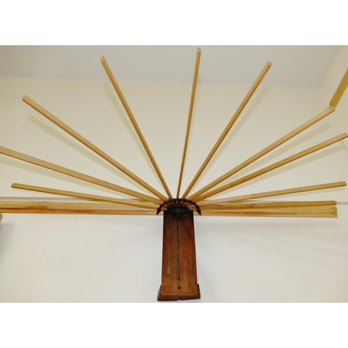 55 - An early 20th century wall mounted folding airer, the 10 sticks each 54cm long, with pine back panel... 