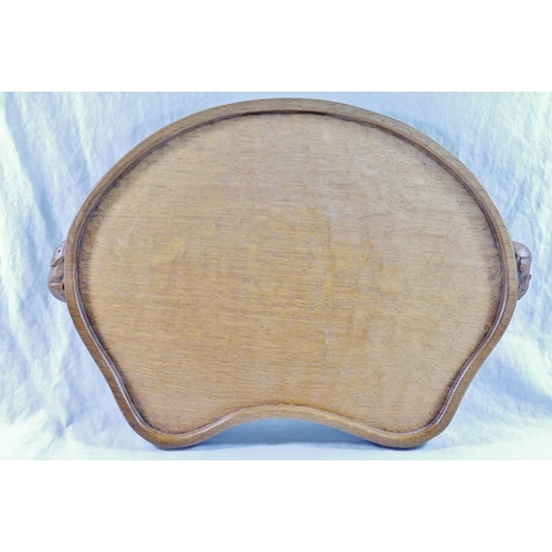 57 - Workshop of Robert Thompson of Kilburn a Mouseman oak kidney shaped tray, the rim carved with two tr... 