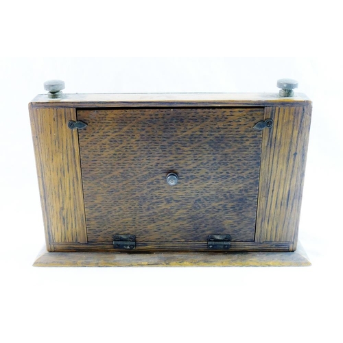 58 - An early 20th century oak desk calendar, with brass front (original silver plate removed through pol... 