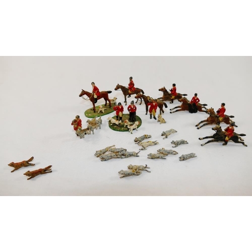 67 - A collection of hand painted cast lead hunting figures, including two foxes, hounds, puppies, horses... 