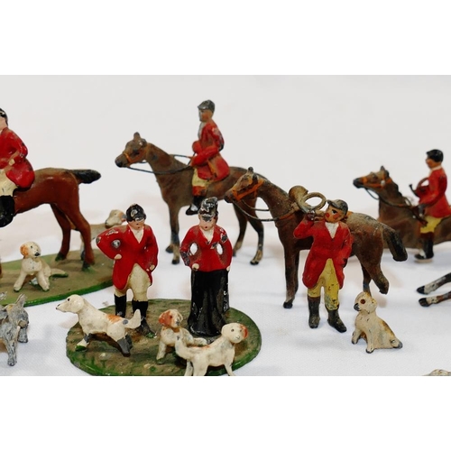 67 - A collection of hand painted cast lead hunting figures, including two foxes, hounds, puppies, horses... 