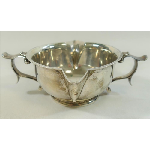 87 - An Arts and Crafts silver two handled and double spouted porringer style bowl, London 1890 by George... 