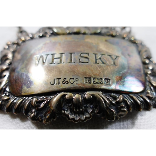 88 - A pair of silver decanter labels, Birmingham 1981, engraved 'Whisky' and 'Sherry', and another silve... 