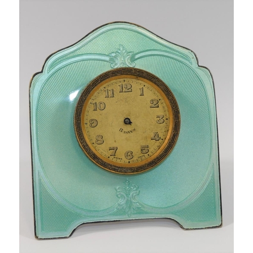24A - A silver coloured metal and guilloche enamelled easel backed clock, the face with Arabic numerals an... 