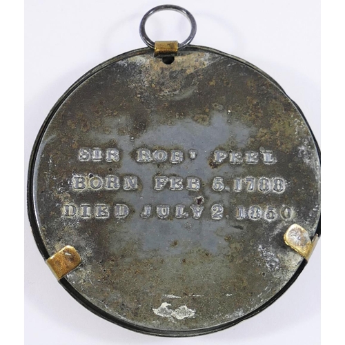 36 - A 19th century miniature gilt metal relief bust of Sir Robert Peel, mounted on beige velvet, within ... 