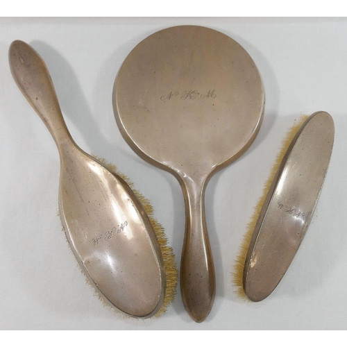 122 - A silver backed three piece dressing table set, Birmingham 1922, comprised of a hand mirror and two ... 