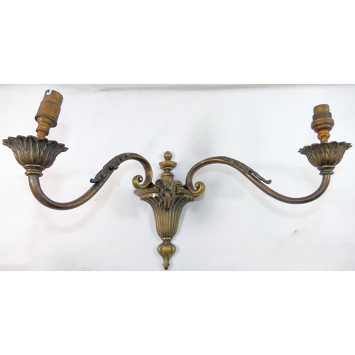 80 - Three two-light brass wall lights, of neoclassical design cast with ram's head and acanthus leaf dec... 