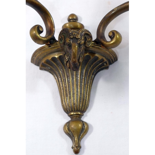 80 - Three two-light brass wall lights, of neoclassical design cast with ram's head and acanthus leaf dec... 