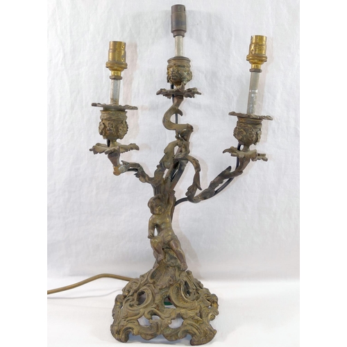 81 - An ornate brass three light candleabra, cast with a cherub and converted to electricity, 38cm high, ... 