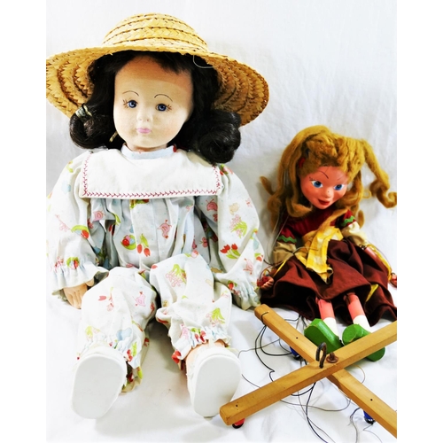 98 - A Pelham puppet 'Gretel' 31cm long, and a cloth doll, with fabric covered moulded face, in play suit... 