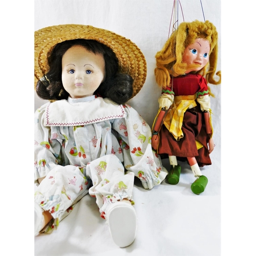 98 - A Pelham puppet 'Gretel' 31cm long, and a cloth doll, with fabric covered moulded face, in play suit... 