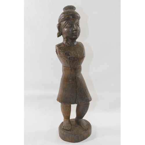 122 - An Indian carved wooden figure, moving arms lacking, 35cm high