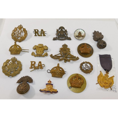 137 - A collection of military cap badges including Royal Welsh Fusiliers, Manchester Regiment and Royal A... 