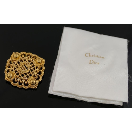 159 - A small quantity of costume jewellery comprised of a large Christian Dior gold-plated brooch, 5.3cm ... 