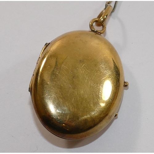 171 - A 19th century French gold oval locket, set with single red stone within inlaid black enamel surroun... 