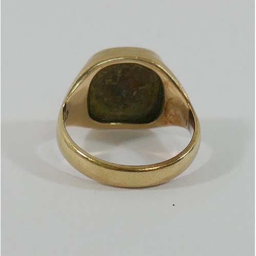 172 - A yellow metal signet ring, intaglio carved with the crest of the palm of a hand, finger size H 1/2,... 