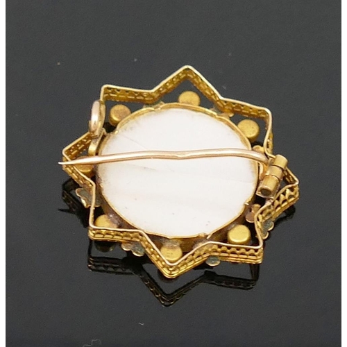 184 - A small French gold seed pearl set brooch, with central circular glazed keepsake panel, and a small ... 