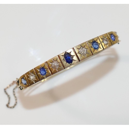 189 - A late19th/early 20th century possibly French sapphire and diamond set hinged bangle, the four old-c... 