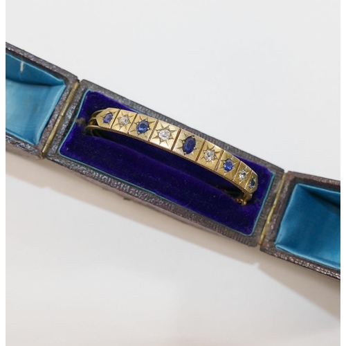 189 - A late19th/early 20th century possibly French sapphire and diamond set hinged bangle, the four old-c... 