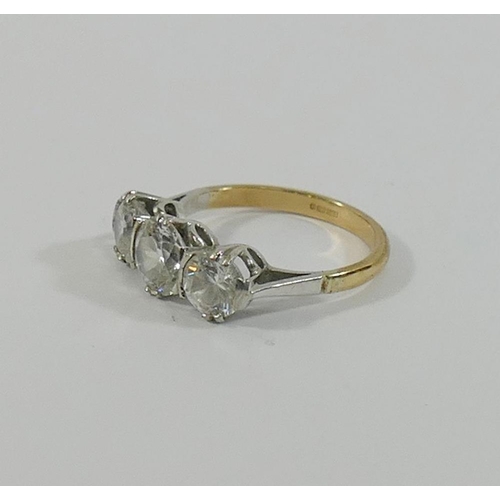 191 - A 9 carat gold diamond simulant three-stone ring, the stones claw-set in white to a yellow shank, fi... 