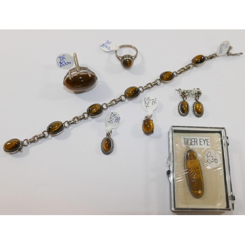 199 - A selection of tiger's eye jewellery comprised of a string of cylindrical beads, a silver tiger's ey... 