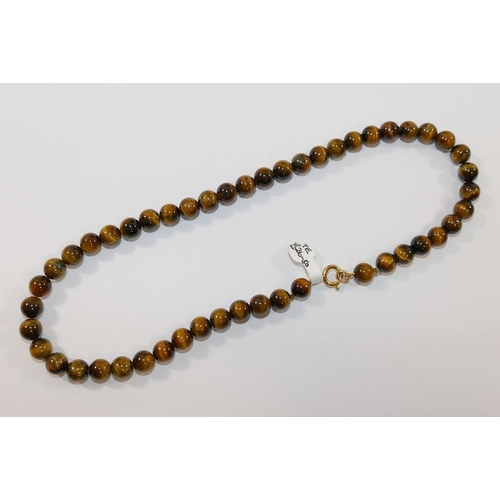 199 - A selection of tiger's eye jewellery comprised of a string of cylindrical beads, a silver tiger's ey... 