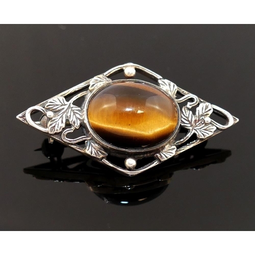 201 - Four items of tiger's eye jewellery comprised of a large single stone ring, a circular openwork broo... 