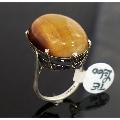 201 - Four items of tiger's eye jewellery comprised of a large single stone ring, a circular openwork broo... 