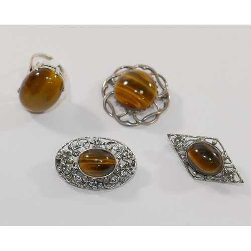 201 - Four items of tiger's eye jewellery comprised of a large single stone ring, a circular openwork broo... 