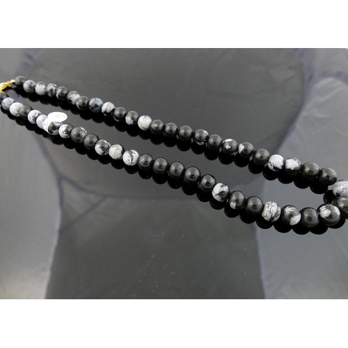 203 - A selection of snowflake obsidian and serpentine jewellery, comprised of a snowflake obsidian gradua... 