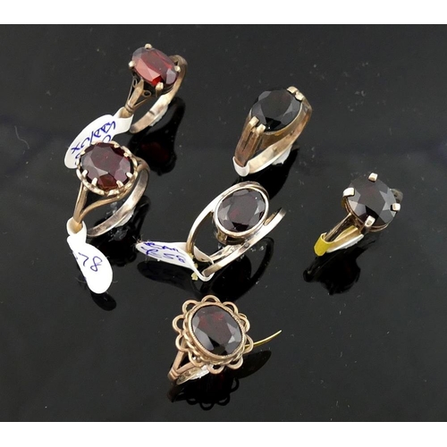 215 - A collection of 12 red garnet set rings, including some set with marcasite, most stamped 'silver' or... 