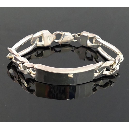 217 - A heavy silver identity bracelet, the rectangular panel 13mm wide with Figaro links

We are pleased ... 